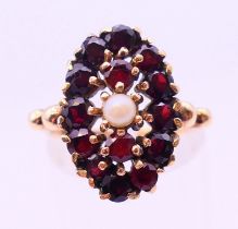 A 9 ct gold garnet and seed pearl ring. Ring size L.