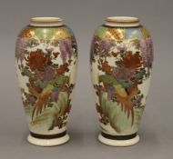 A pair of 19th century Satsuma vases decorated with racemes of wisteria. Signed to base. 15 cm high.