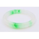 A two-tone jade bangle. 5.5 cm internal diameter.