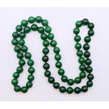 A string of jade beads. 82 cm long.