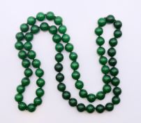 A string of jade beads. 82 cm long.