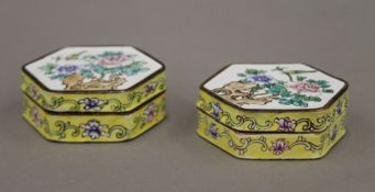 A pair of enamel hexagonal boxes decorated with a bird perched on a flower. Each 6 cm wide.