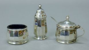 A silver three-piece cruet set. The pepper 7 cm high. 69.3 grammes.