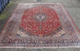 A large red ground rug. 294 x 400 cm.