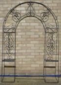 A wrought iron garden arch. 135 cm wide x 198 cm high.