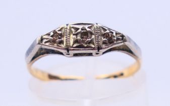 An 18 ct gold and platinum diamond ring. Ring size J.