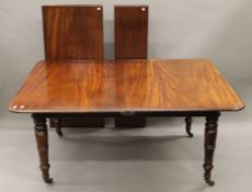 A 19th century mahogany two-leaf pull-out extending dining table.