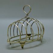 A silver toast rack stamped Goldsmiths and Silversmiths Ltd. 16 cm long. 179.4 grammes.