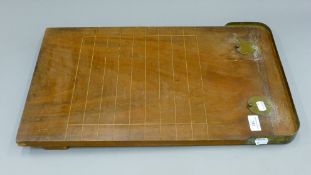 A Victorian walnut Shove Ha'penny board with original playing coins in pockets. 35 cm wide.
