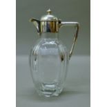 A silver-mounted glass claret jug. 22.5 cm high.