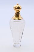 An 18 ct gold topped French scent bottle. 10 cm high.