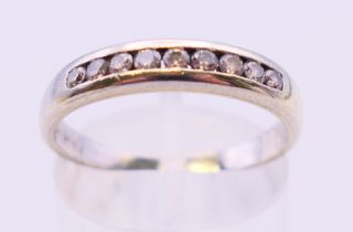 A 9 ct white gold half eternity ring. Ring size P.