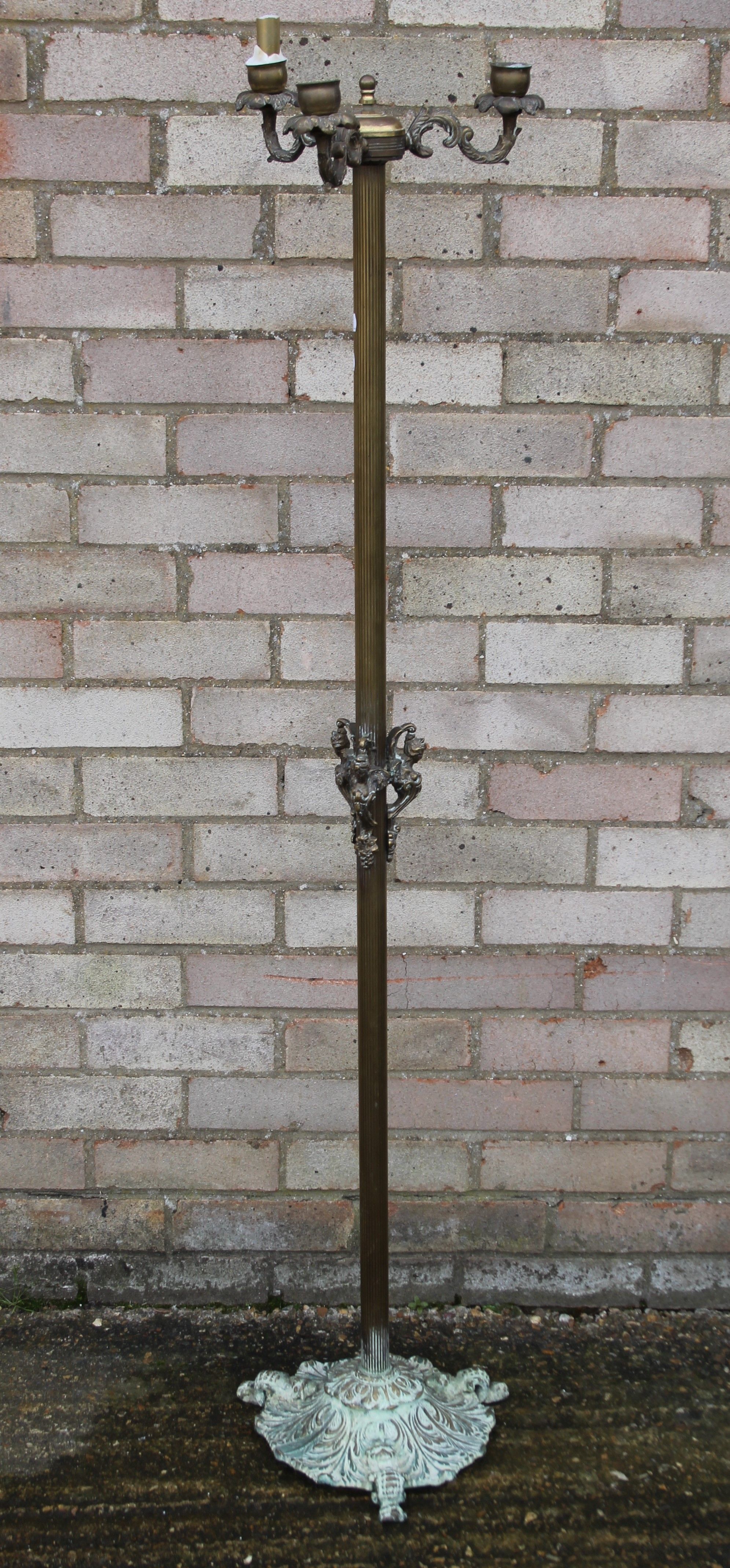 A brass candle stand. 143 cm high.