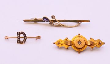 Three 9 ct gold brooches, one with pearls set within a 'D', all boxed. The largest 6 cm long. 5.