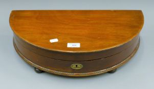 A vacant mahogany demi-lune cutlery canteen. 50 cm wide.