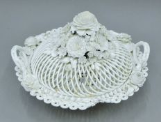 A 19th century florally encrusted porcelain basket. 30 cm wide.