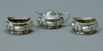 A silver three-piece cruet set. The mustard pot 8.5 cm long. 165.4 grammes.