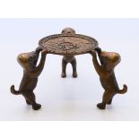 A Chinese small stand supported by three dog figures. 4 cm high.