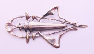 A silver brooch in the form of a locust. 9 cm x 5 cm.