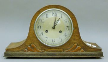 An oak wall clock, another wall clock and an oak mantle clock. The former 64 cm high.