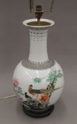 A Chinese porcelain lamp decorated with birds amongst floral sprays. 71 cm high overall.