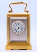 A silvered dial miniature carriage clock. 5.5 cm high excluding handle.