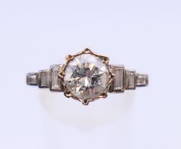 A 9 ct and 18 ct gold and diamond ring. The central stone spreading to approximately 0.75 ct.