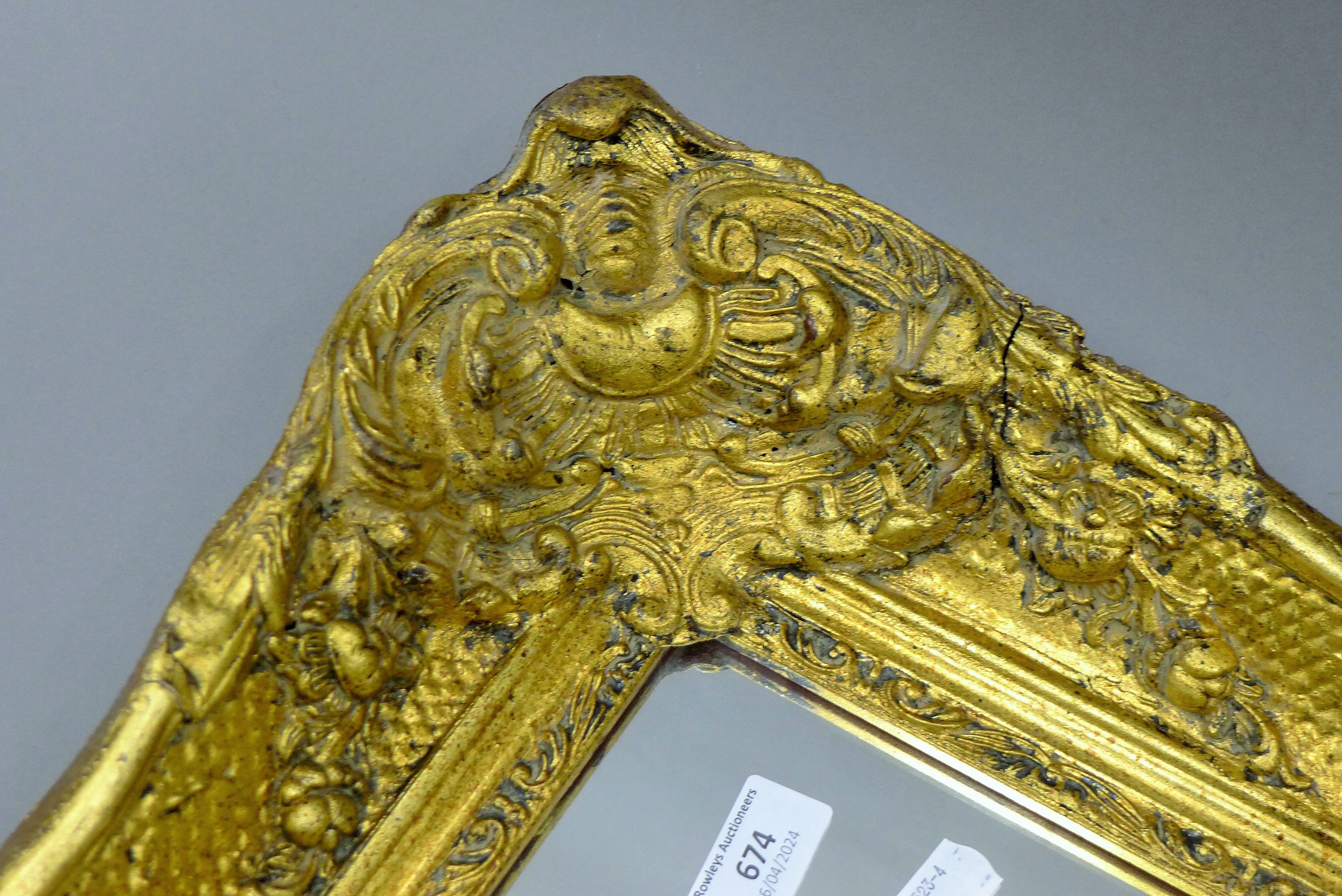 A wall mirror in a large ornate gilt frame 49 x 59 cm overall. - Image 2 of 2