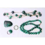 A collection of vintage marbled green malachite jewellery, to include: two necklaces,