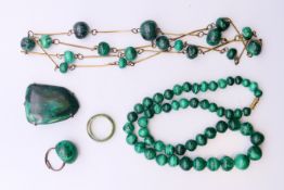 A collection of vintage marbled green malachite jewellery, to include: two necklaces,