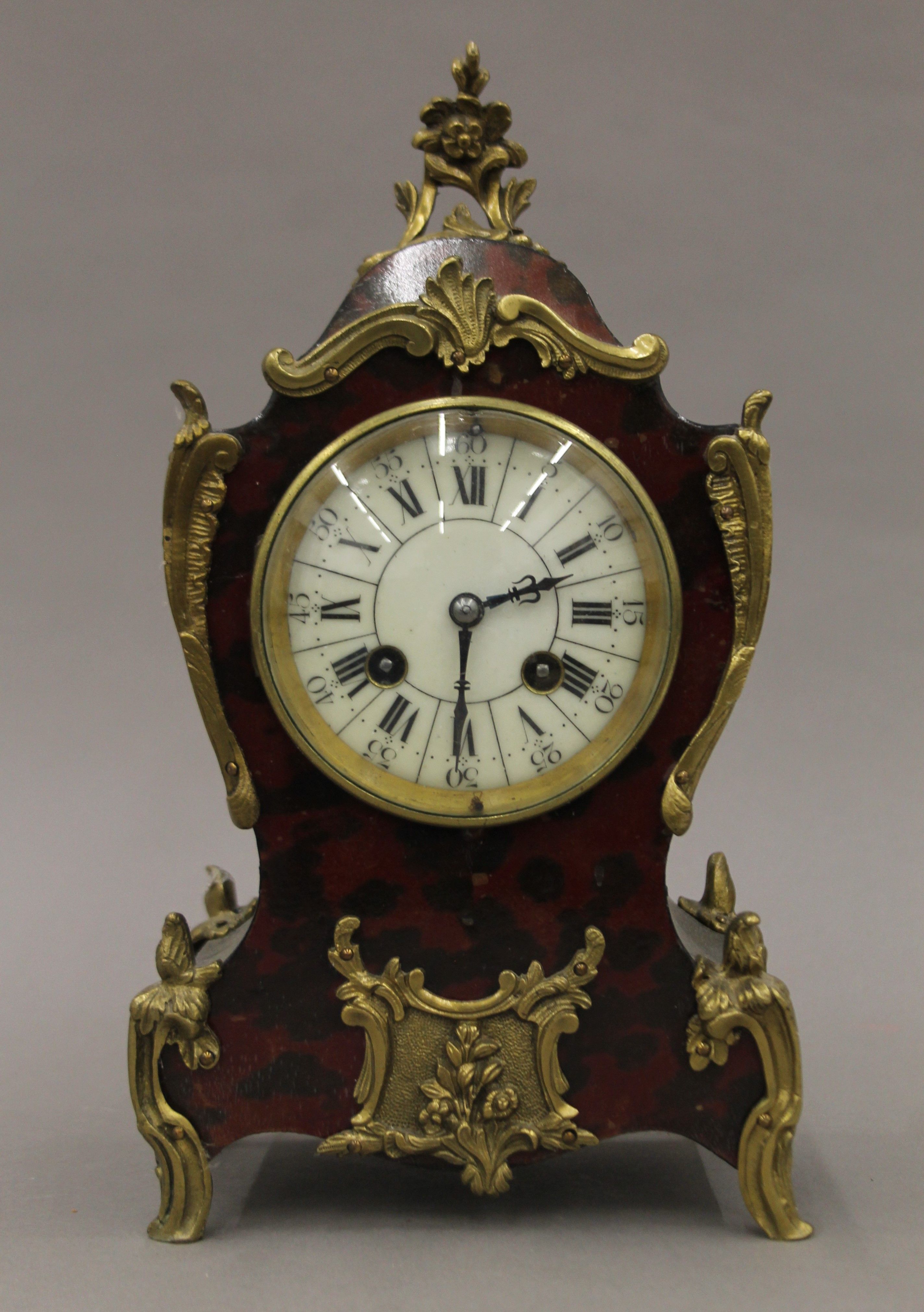 An early 20th century faux tortoiseshell mantle clock. 29 cm high.