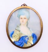 A 19th century hand-painted miniature portrait on ivory of a lady in a blue and olive-coloured