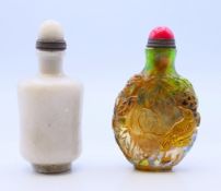 Two Chinese snuff bottles and stoppers. The largest 8 cm high.
