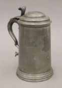 A 19th century pewter lidded tankard with scratch fours inscription. 21 cm high.