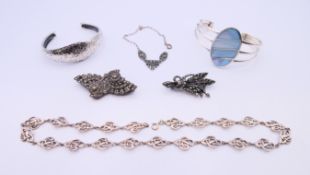 A quantity of silver jewellery, to include: two bangles, two brooches, a necklace, etc 110.