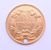 An 1862 American one dollar gold coin, pierced with suspension hole. 1.5 cm diameter. 1.6 grammes.