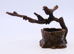 A bronze of a bird on a tree branch. 5.5 cm high.