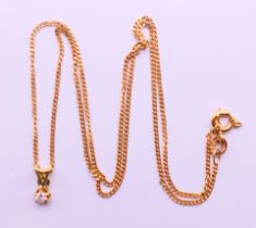 A diamond pendant on a 9 ct gold chain. Pendant 0.75 cm high, chain 39 cm long.