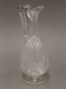A 19th century glass claret jug, hand chased with fox. 28 cm high.
