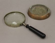 A magnifying glass and a copper ashtray. The former 26 cm high.