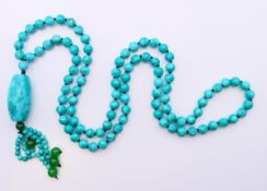 A string of turquoise beads with turquoise pendant. Necklace 82 cm long, pendant 9 cm high.