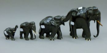 Four carved ebony and bone elephants. The largest 17 cm high.