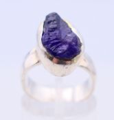 A handmade hammered silver ring, set with uncut amethyst. Ring size K/L.