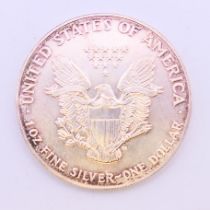 A 1992 one ounce fine silver USA one dollar coin.