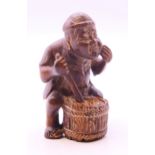 A netsuke formed as a man and a drum. 5.5 cm high.