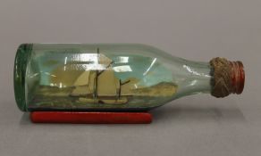 A miniature boat in a bottle. 11 cm long.