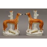 A pair of 19th century Staffordshire greyhound and hare models (left and right),