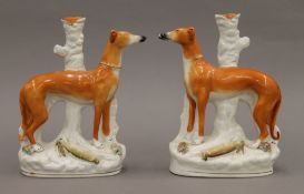 A pair of 19th century Staffordshire greyhound and hare models (left and right),