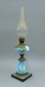 A 19th century painted blue glass oil lamp. 33 cm high excluding chimney.