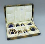 A part-cased set of Rosenthal porcelain coffee cans and saucers. The case 39 cm wide.